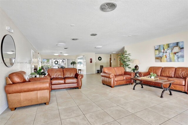 551 NW 80th Ter Unit 203, Margate, FL 33063 - living room with light tile patterned floors and a textured ceiling