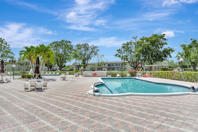 551 NW 80th Ter Unit 203, Margate, FL 33063 - community pool featuring a patio area