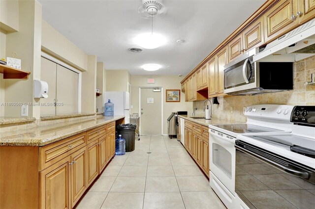 551 NW 80th Ter Unit 203, Margate, FL 33063 - kitchen with white appliances, tasteful backsplash, a sink, light tile patterned floors, and light stone counters