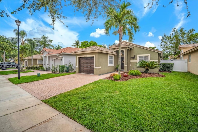 16408 Sapphire Bnd, Weston, FL 33331 - mediterranean / spanish-style house featuring decorative driveway, stucco siding, a tiled roof, and an attached garage
