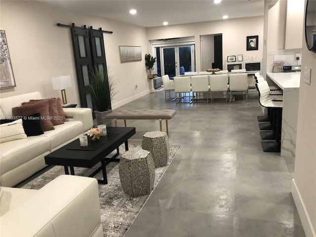 9224 Byron Ave, Surfside, FL 33154 - living room featuring finished concrete floors, recessed lighting, a barn door, and baseboards