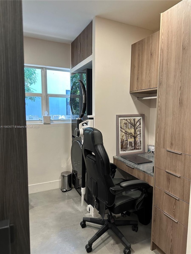 9224 Byron Ave, Surfside, FL 33154 - home office with stacked washer / drying machine, finished concrete floors, and baseboards