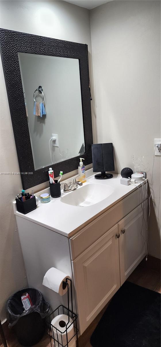bathroom with vanity and wood finished floors