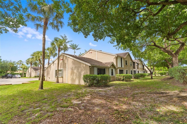 9641 Riverside Dr Unit F6, Coral Springs, FL 33071 - view of home's exterior featuring stucco siding and a yard