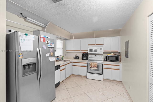 9641 Riverside Dr Unit F6, Coral Springs, FL 33071 - kitchen featuring appliances with stainless steel finishes, a sink, light countertops, white cabinetry, and a textured ceiling