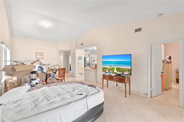 9641 Riverside Dr Unit F6, Coral Springs, FL 33071 - bedroom with stainless steel fridge with ice dispenser, lofted ceiling, and light tile patterned floors