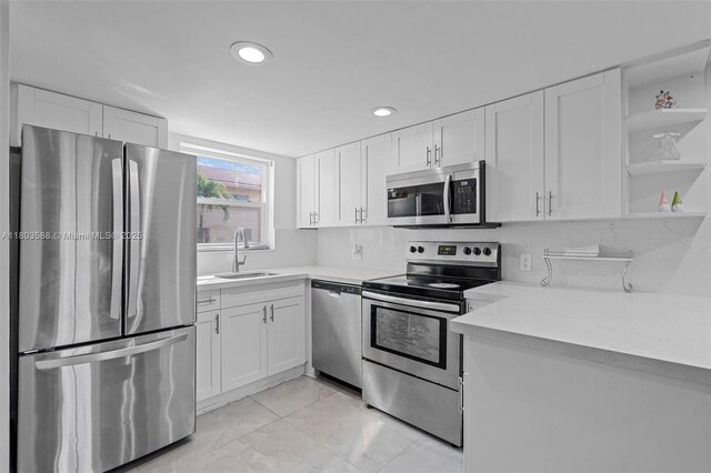 5530 W 26th Ct Unit 209, Hialeah, FL 33016 - kitchen featuring appliances with stainless steel finishes, a sink, open shelves, white cabinetry, and recessed lighting