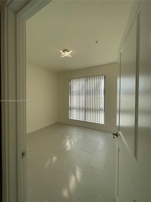 tiled spare room with baseboards