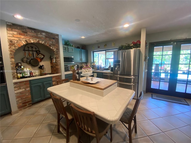 2180 SW 115th Ter, Davie, FL 33325 - kitchen featuring appliances with stainless steel finishes, light tile patterned flooring, light countertops, and recessed lighting