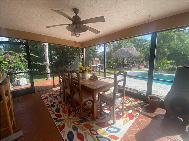 2180 SW 115th Ter, Davie, FL 33325 - sunroom / solarium featuring a textured ceiling, ceiling fan, brick floors, and outdoor dining area
