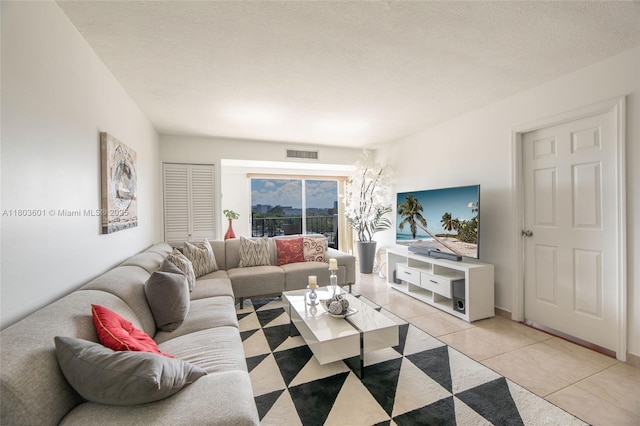 1625 SE 10th Ave Unit 607, Fort Lauderdale, FL 33316 - living room featuring light tile patterned floors and a textured ceiling