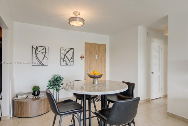 1625 SE 10th Ave Unit 607, Fort Lauderdale, FL 33316 - dining room with light tile patterned flooring and baseboards