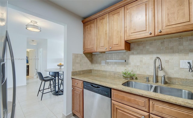 1625 SE 10th Ave Unit 607, Fort Lauderdale, FL 33316 - kitchen with stainless steel appliances, a sink, light tile patterned floors, decorative backsplash, and light stone counters