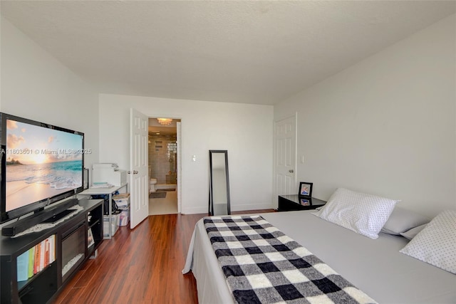 1625 SE 10th Ave Unit 607, Fort Lauderdale, FL 33316 - bedroom with dark wood-style flooring, ensuite bath, and baseboards
