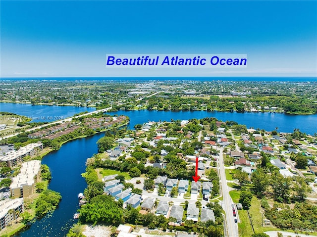 aerial view of residential area featuring a nearby body of water