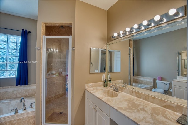 full bathroom featuring a stall shower, a garden tub, and vanity