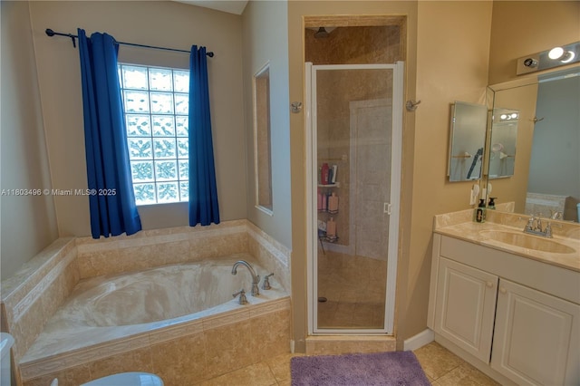 bathroom with a stall shower, a garden tub, healthy amount of natural light, and vanity