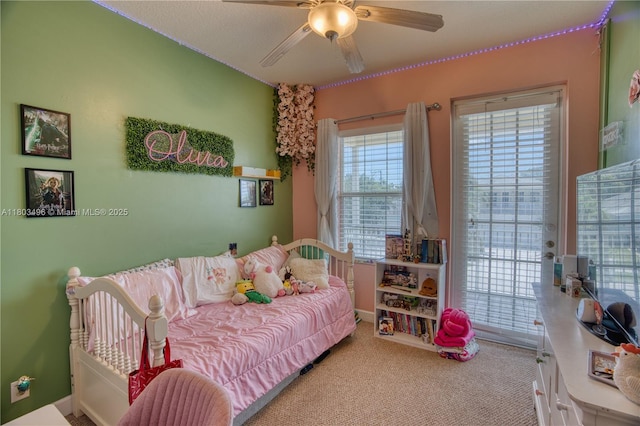 bedroom with access to outside, carpet flooring, and a ceiling fan