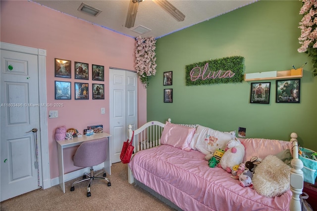 carpeted bedroom with a closet and ceiling fan