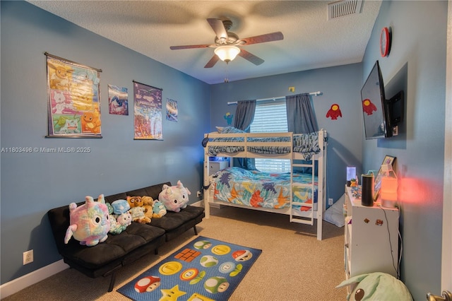 carpeted bedroom featuring a textured ceiling and ceiling fan