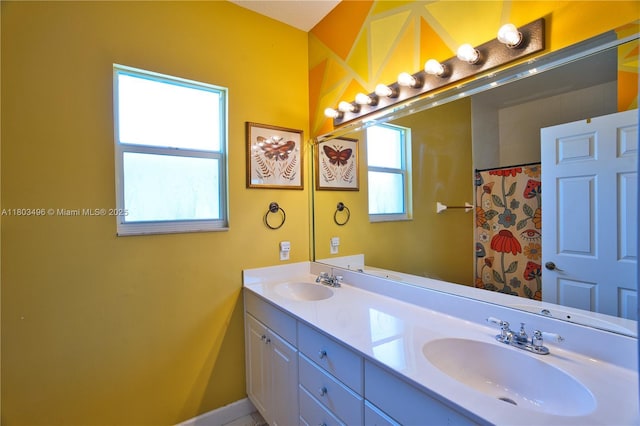 bathroom with plenty of natural light, double vanity, baseboards, and curtained shower
