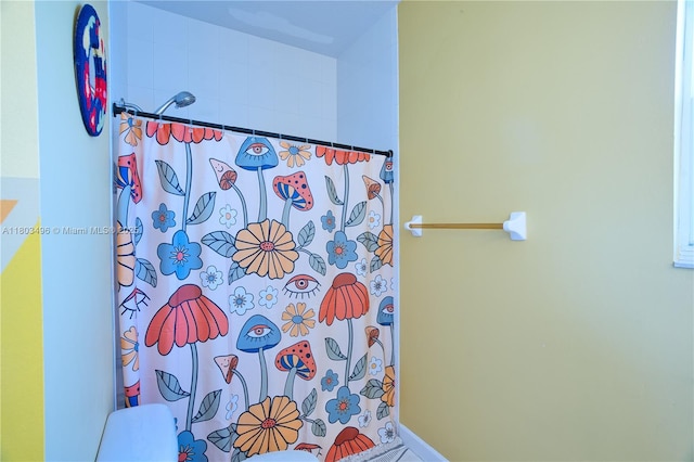 bathroom featuring curtained shower and toilet