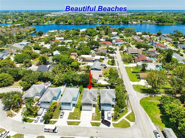 aerial perspective of suburban area featuring a nearby body of water