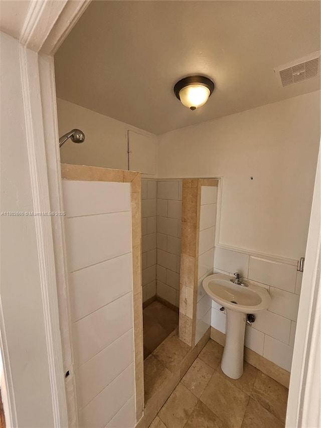 900 16th St Unit 207, Miami Beach, FL 33139 - bathroom featuring a walk in shower and tile walls
