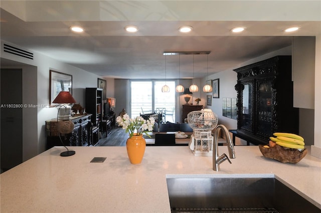 401 SE 3rd St Unit 403, Dania Beach, FL 33004 - kitchen featuring a sink, recessed lighting, pendant lighting, and light countertops