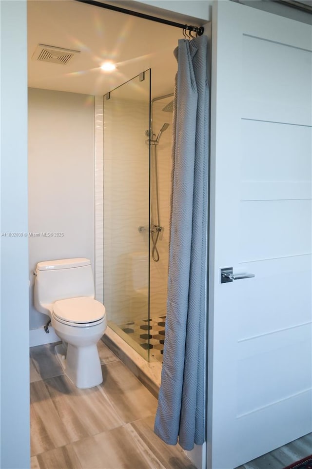 401 SE 3rd St Unit 403, Dania Beach, FL 33004 - bathroom featuring a stall shower, toilet, and wood finished floors