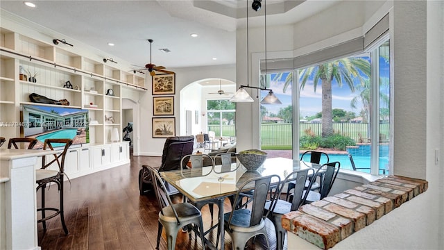 2495 Eagle Watch Ln, Weston, FL 33327 - dining room featuring arched walkways, a ceiling fan, dark wood-type flooring, crown molding, and recessed lighting