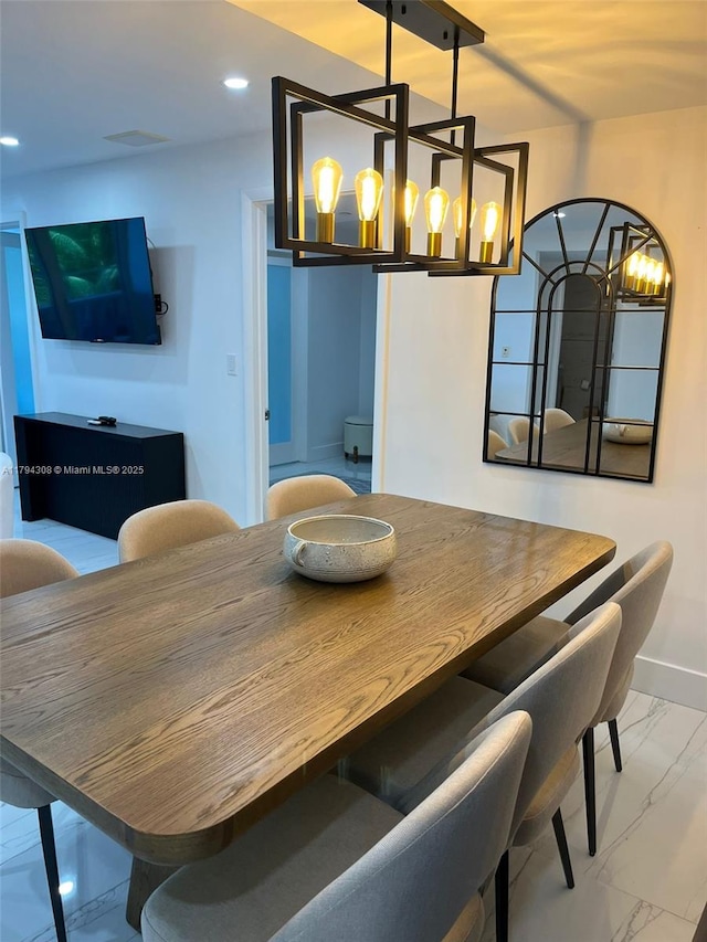 2301 Collins Ave Unit 326, Miami Beach, FL 33139 - dining space with marble finish floors, a chandelier, baseboards, and recessed lighting