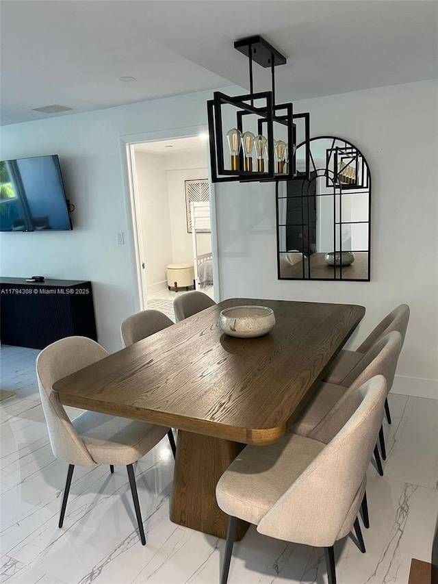 2301 Collins Ave Unit 326, Miami Beach, FL 33139 - dining area featuring light marble finish floors and baseboards