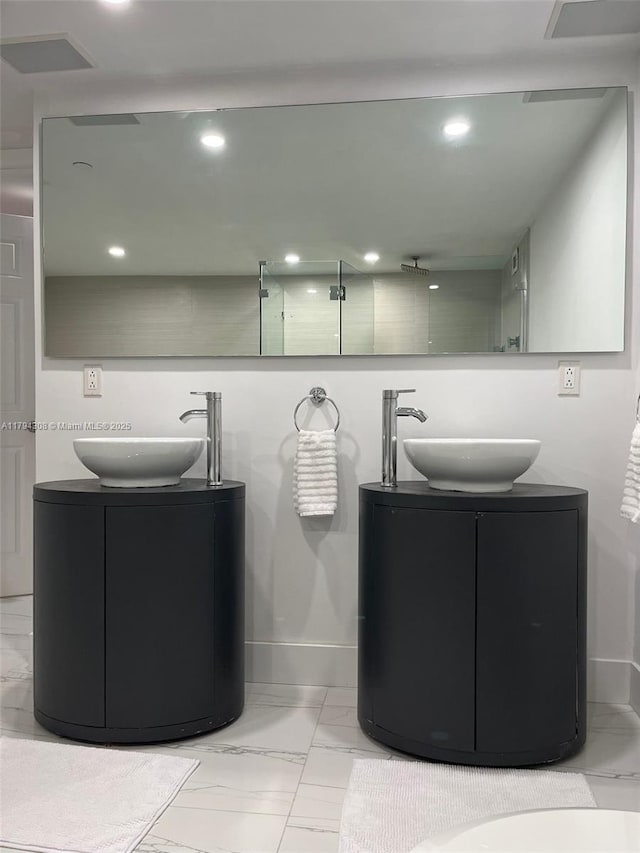 2301 Collins Ave Unit 326, Miami Beach, FL 33139 - bathroom with double vanity, marble look tiles, and recessed lighting