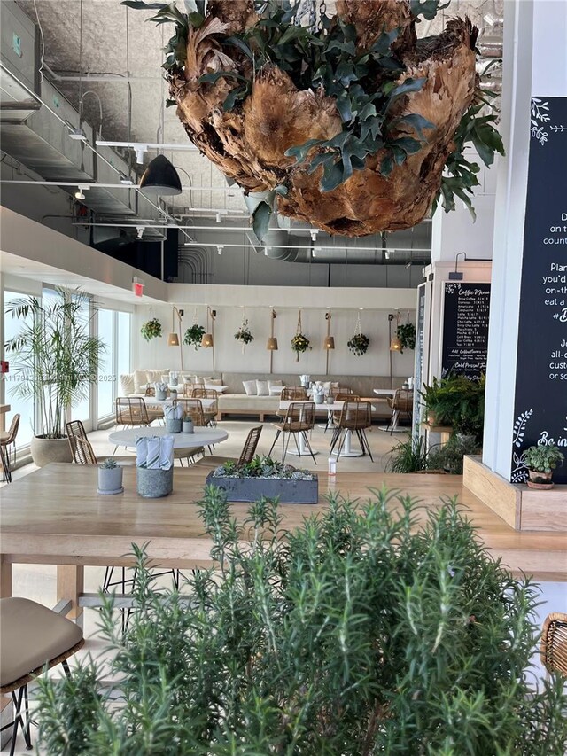 2301 Collins Ave Unit 326, Miami Beach, FL 33139 - dining room featuring a towering ceiling and wood finished floors