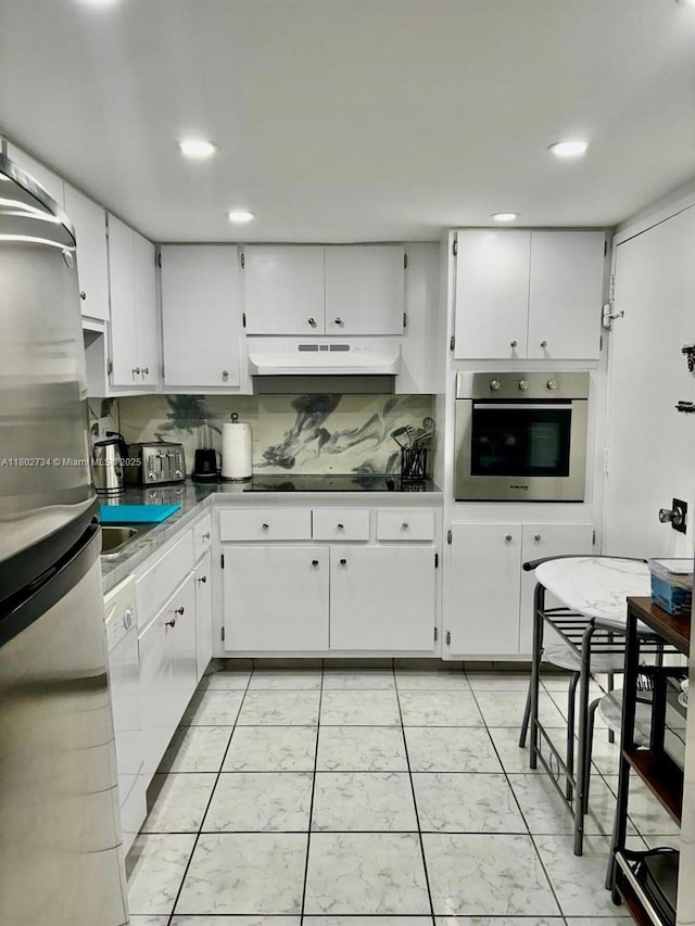 400 Kings Point Dr Unit 928, Sunny Isles Beach, FL 33160 - kitchen featuring stainless steel appliances, under cabinet range hood, white cabinetry, recessed lighting, and a sink