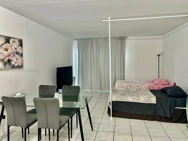 400 Kings Point Dr Unit 928, Sunny Isles Beach, FL 33160 - bedroom featuring a textured ceiling and light tile patterned flooring