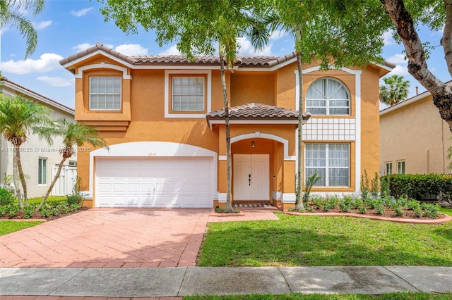 2238 NW 139th Ave, Sunrise, FL 33323 - mediterranean / spanish house featuring a garage, a tiled roof, stucco siding, driveway, and a front yard