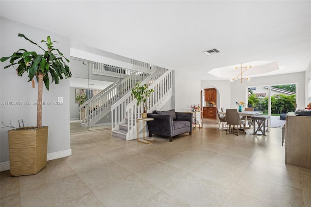 2238 NW 139th Ave, Sunrise, FL 33323 - living area with stairway, arched walkways, a chandelier, and baseboards