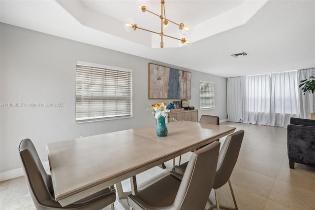 2238 NW 139th Ave, Sunrise, FL 33323 - dining room with a chandelier, a raised ceiling, and baseboards