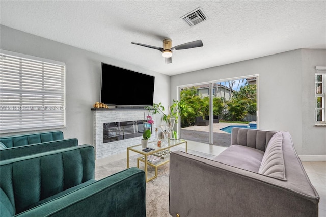 2238 NW 139th Ave, Sunrise, FL 33323 - carpeted living room featuring a ceiling fan, baseboards, a fireplace, and a textured ceiling