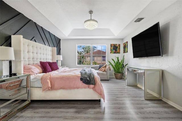 2238 NW 139th Ave, Sunrise, FL 33323 - bedroom with a tray ceiling, wood finished floors, and baseboards