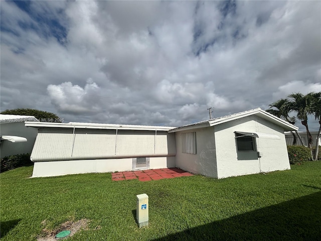 back of house with a lawn