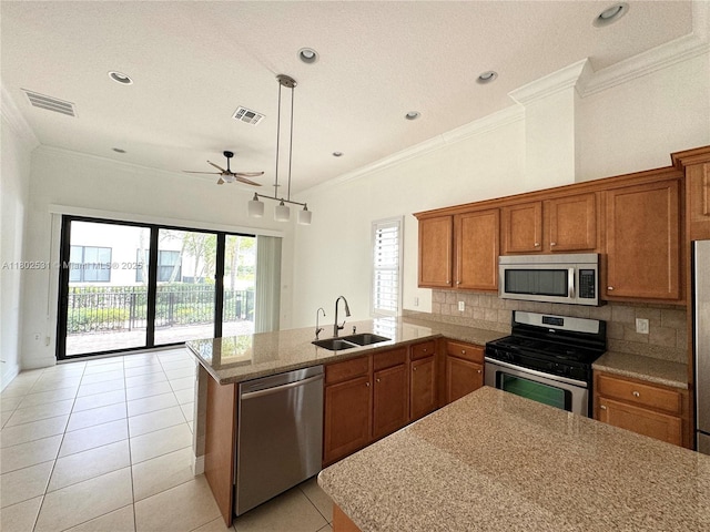 12490 NW 33rd St, Sunrise, FL 33323 - kitchen featuring appliances with stainless steel finishes, a sink, brown cabinets, ornamental molding, and ceiling fan