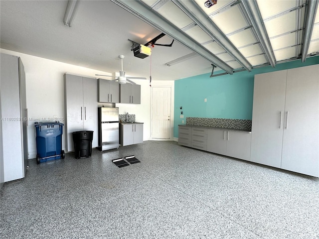 12490 NW 33rd St, Sunrise, FL 33323 - garage featuring freestanding refrigerator, a ceiling fan, and a garage door opener
