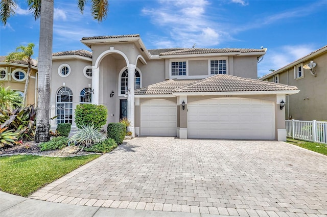 12339 NW 25th St, Coral Springs, FL 33065 - mediterranean / spanish-style home featuring stucco siding, a tiled roof, and decorative driveway