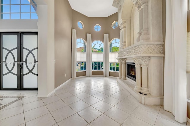 12339 NW 25th St, Coral Springs, FL 33065 - foyer entrance featuring a towering ceiling, healthy amount of natural light, tile patterned floors, baseboards, and french doors