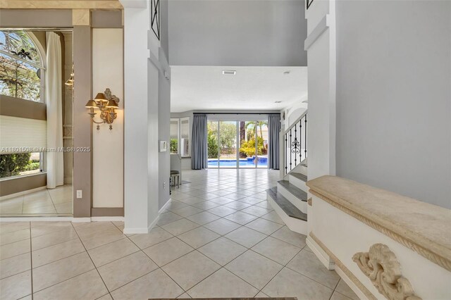 12339 NW 25th St, Coral Springs, FL 33065 - entryway featuring light tile patterned floors, healthy amount of natural light, and stairs