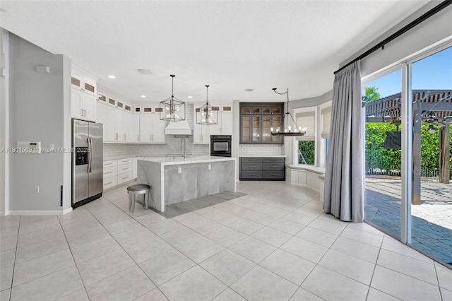 12339 NW 25th St, Coral Springs, FL 33065 - kitchen with stainless steel fridge with ice dispenser, oven, a chandelier, light countertops, and light tile patterned floors