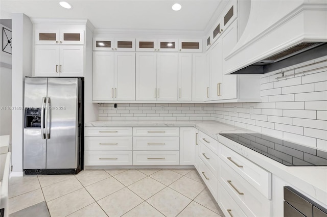 12339 NW 25th St, Coral Springs, FL 33065 - kitchen featuring stainless steel fridge, custom exhaust hood, tasteful backsplash, white cabinetry, and light stone countertops